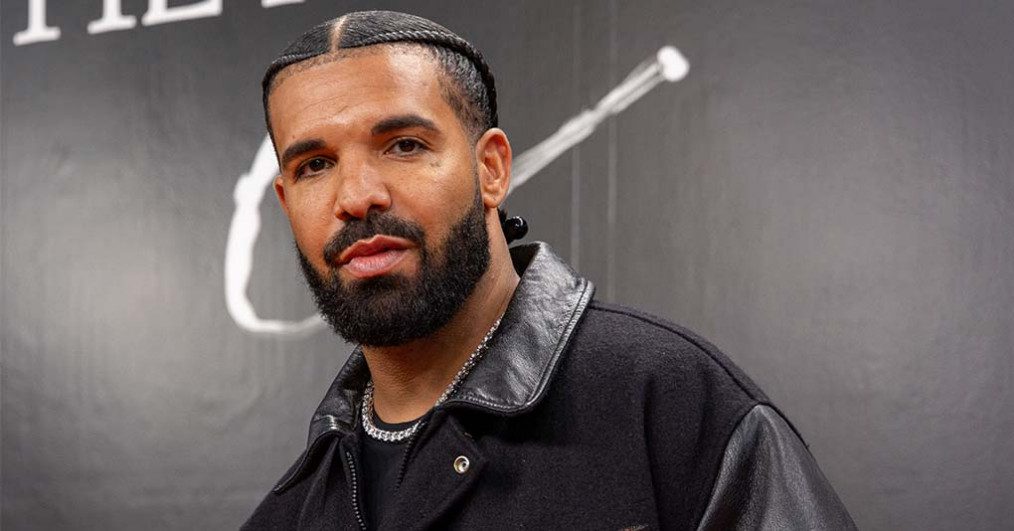 Drake walks on the orange carpet at NIKE, Inc.